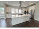 Modern kitchen with a large center island, stainless steel appliances, and sleek white cabinetry at 6023 Chester Way, Denver, CO 80238