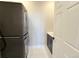 Laundry room featuring stacked washer and dryer units and a utility sink at 6023 Chester Way, Denver, CO 80238