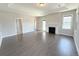 Spacious living room with hardwood floors, fireplace, and large windows providing ample natural light at 6023 Chester Way, Denver, CO 80238