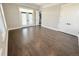 Open-concept living room featuring hardwood floors, double doors, and recessed lighting at 6023 Chester Way, Denver, CO 80238