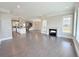 Bright, open-concept living space with hardwood floors, a fireplace, and a modern kitchen at 6023 Chester Way, Denver, CO 80238