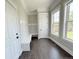 Bright mudroom with bench seating, coat hooks, storage, and natural light from large windows at 6023 Chester Way, Denver, CO 80238