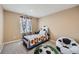 Well-lit bedroom with decorative bed, carpet, and a window providing natural light at 10677 Cedarcrest Cir, Highlands Ranch, CO 80130