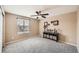 Neutral bedroom with window, carpet, and a console table with decorative items at 10677 Cedarcrest Cir, Highlands Ranch, CO 80130