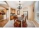 Cozy dining room with carpet, a round table, decorative chairs, and a view into the kitchen, perfect for intimate gatherings at 10677 Cedarcrest Cir, Highlands Ranch, CO 80130