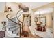 Grand entryway with curved staircase and views into the dining room at 10677 Cedarcrest Cir, Highlands Ranch, CO 80130