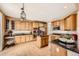 Spacious kitchen featuring wooden cabinets, granite countertops, stainless steel appliances, and a central island at 10677 Cedarcrest Cir, Highlands Ranch, CO 80130