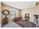 A sunlit living room with carpeted floors, a large window, and stylish decor at 10677 Cedarcrest Cir, Highlands Ranch, CO 80130