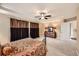 Spacious Primary bedroom featuring plush carpets, tray ceilings, and elegant window treatments at 10677 Cedarcrest Cir, Highlands Ranch, CO 80130