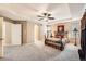 Well-lit Primary bedroom with tray ceilings, soft carpeting, and ample natural light at 10677 Cedarcrest Cir, Highlands Ranch, CO 80130