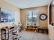 Bright home office featuring a desk, chair, shelving, and a window with blinds, creating a functional workspace at 10677 Cedarcrest Cir, Highlands Ranch, CO 80130