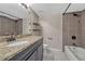 Bathroom with granite vanity top, dark vanity, shower and tub combination at 3337 S Monaco Pkwy # C, Denver, CO 80222