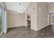 Dining area with wood floors, a modern chandelier and views of the kitchen at 3337 S Monaco Pkwy # C, Denver, CO 80222