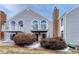 Two-story townhome featuring a chimney and upper level decks with white railing at 3337 S Monaco Pkwy # C, Denver, CO 80222