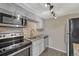 Cozy kitchen features stainless steel appliances, granite countertops, and updated cabinetry at 3337 S Monaco Pkwy # C, Denver, CO 80222