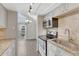Bright kitchen with stainless appliances, granite counters, and an adjacent dining area with outdoor access at 3337 S Monaco Pkwy # C, Denver, CO 80222