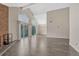 Spacious living room with wood floors, high ceilings, brick fireplace, and balcony access at 3337 S Monaco Pkwy # C, Denver, CO 80222