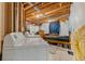 Unfinished basement utility area featuring laundry machines, bed, and exposed ceiling structure and utilities at 24022 E Jamison Dr, Aurora, CO 80016