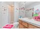 Charming bathroom features shower, vanity and mirror, plus whimsical doll stickers for a playful touch at 24022 E Jamison Dr, Aurora, CO 80016