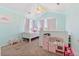 Bright bedroom features light walls, fan, and plush carpeting, creating a cozy and inviting atmosphere at 24022 E Jamison Dr, Aurora, CO 80016