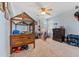 Bedroom with unique wooden bedframe, carpeted floors, and a large window for natural light at 24022 E Jamison Dr, Aurora, CO 80016
