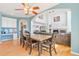 Open concept dining room featuring hardwood floors, a large wood table, and views into a living room with fireplace at 24022 E Jamison Dr, Aurora, CO 80016