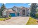 Charming two-story home with a brick facade, arched entry, and three car garage at 24022 E Jamison Dr, Aurora, CO 80016
