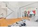 Open foyer with hardwood floors, staircase, and view into dining room at 24022 E Jamison Dr, Aurora, CO 80016