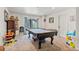 Basement game room with pool table, natural light from walkout slider, and space for toys and entertainment at 24022 E Jamison Dr, Aurora, CO 80016