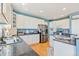 Bright kitchen with white cabinets, stainless steel appliances, and granite countertops at 24022 E Jamison Dr, Aurora, CO 80016