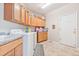 Functional laundry room with ample cabinet space, a sink, and a washing machine at 24022 E Jamison Dr, Aurora, CO 80016