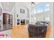 Bright living room featuring a soaring ceiling, large windows, and cozy fireplace at 24022 E Jamison Dr, Aurora, CO 80016