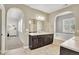 Stylish bathroom with a soaking tub and vanity with dark wood cabinets and countertops at 11404 Lovage Way, Parker, CO 80134