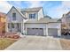 Charming two-story home with a three car garage, a well-manicured lawn, and a cozy front porch at 11404 Lovage Way, Parker, CO 80134