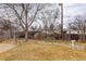 A large backyard featuring rock landscaping, with an arbor, and fenced perimeter at 5271 S Logan St, Littleton, CO 80121