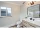 Bright bathroom featuring a modern vanity, sleek fixtures, and a framed mirror at 5271 S Logan St, Littleton, CO 80121