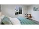 Bedroom with large window, sleek flooring, neutral colors, and picture window with outdoor view at 5271 S Logan St, Littleton, CO 80121