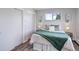 Bedroom features a closet, updated flooring, and a large window with neighborhood views at 5271 S Logan St, Littleton, CO 80121