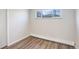 Bedroom featuring a window, neutral colors, and modern vinyl plank flooring at 5271 S Logan St, Littleton, CO 80121