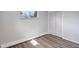 Bedroom featuring a closet, updated flooring, and a window with outdoor view at 5271 S Logan St, Littleton, CO 80121