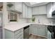 Bright kitchen with stainless steel appliances, updated cabinets, quartz countertops, and modern backsplash at 5271 S Logan St, Littleton, CO 80121