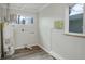 Laundry room with washer/dryer hookups, updated window, and modern flooring at 5271 S Logan St, Littleton, CO 80121