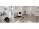 Open-concept living area with wood floors and neutral finishes, with views to a dining area at 5271 S Logan St, Littleton, CO 80121