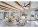 Inviting living room with large windows, exposed beams, comfortable seating, and modern decor at 5271 S Logan St, Littleton, CO 80121