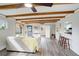 Spacious living room features exposed beams, wood-look flooring, and an open layout ideal for entertaining at 5271 S Logan St, Littleton, CO 80121