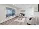 Bright living room featuring modern decor, neutral tones, and wood flooring at 5271 S Logan St, Littleton, CO 80121