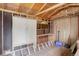 Unfinished storage shed interior with exposed wood beams, cabinet, and ladder at 5271 S Logan St, Littleton, CO 80121