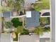 Aerial view of the home's backyard featuring stone pathways, garden beds, and grass at 835 S Shoshone St, Denver, CO 80223
