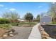 Well-maintained backyard featuring a shed, established garden, and a walking path at 835 S Shoshone St, Denver, CO 80223