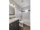 Updated bathroom featuring tiled shower and modern vanity, offering a clean and stylish design at 835 S Shoshone St, Denver, CO 80223